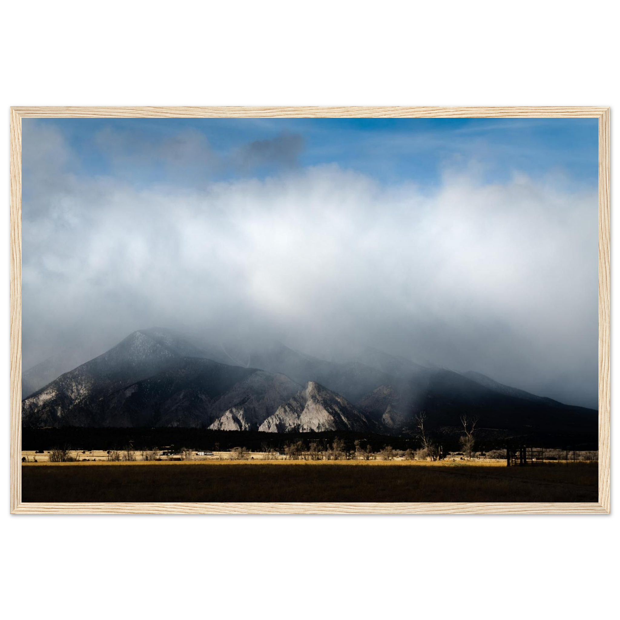 Mountain peak above clouds photography print with blue sky and golden sunlight, dramatic horizontal landscape wall art, framed