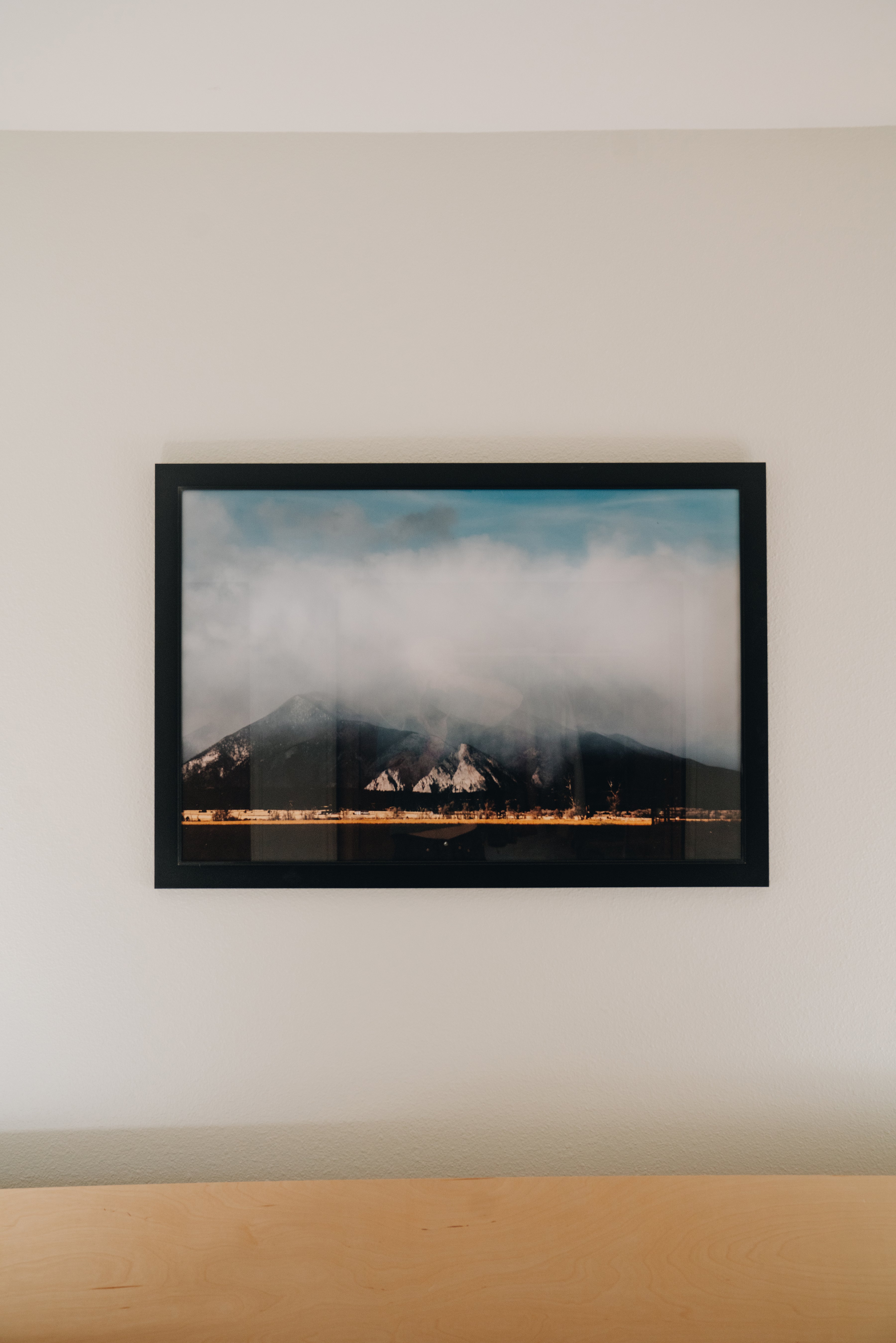 13er mountain peak print in large format displayed above bed, dramatic landscape wall art styling inspiration