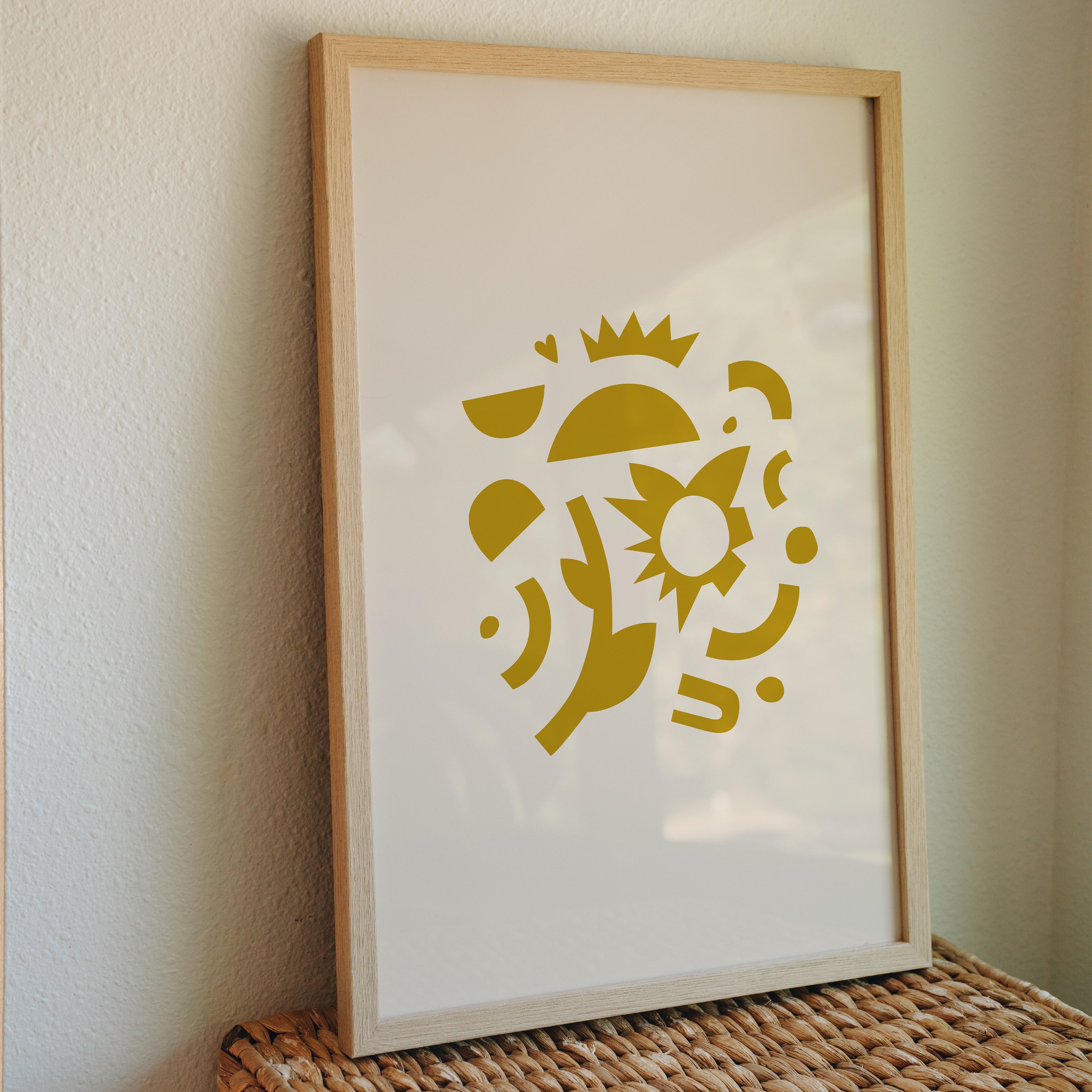 Abstract sun shapes print in golden yellow framed on wicker box against neutral wall, modern minimalist home decor