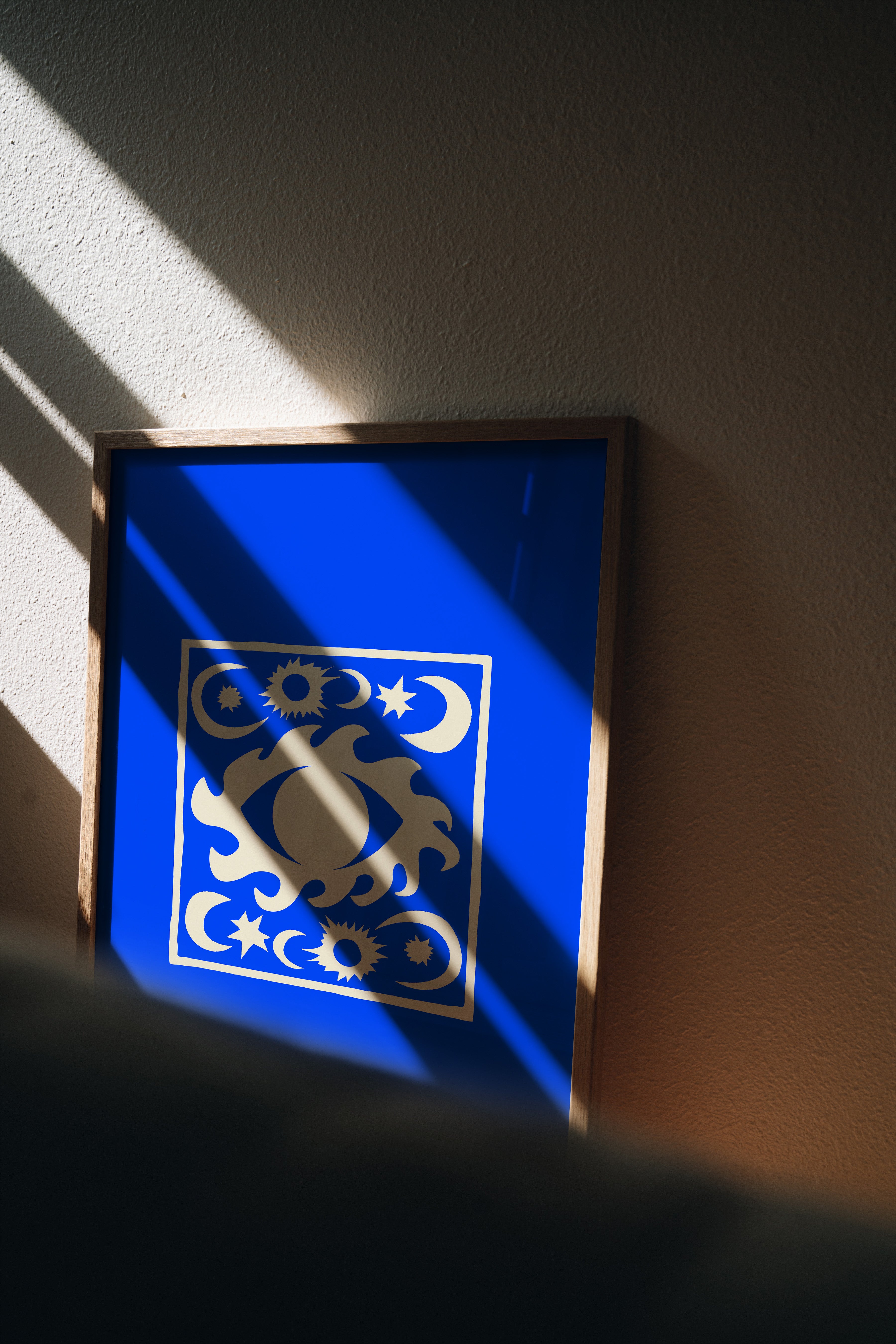 Blue Moon and Stars celestial print displayed in bedroom with natural shadows, dreamy blue wall art styling inspiration