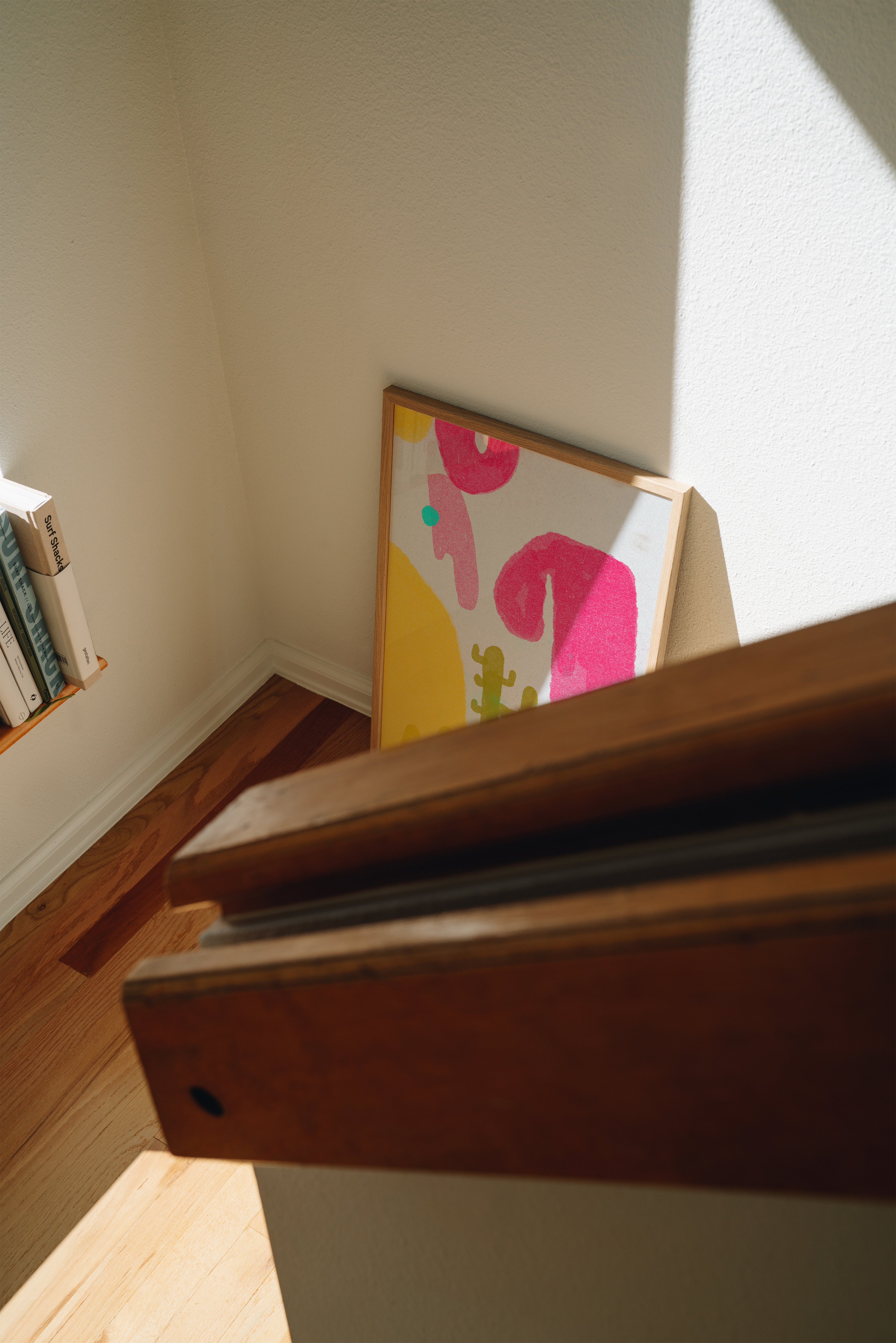Cactus Blobs colorful print in frame propped against wall with natural shadows, playful wall art styling inspiration