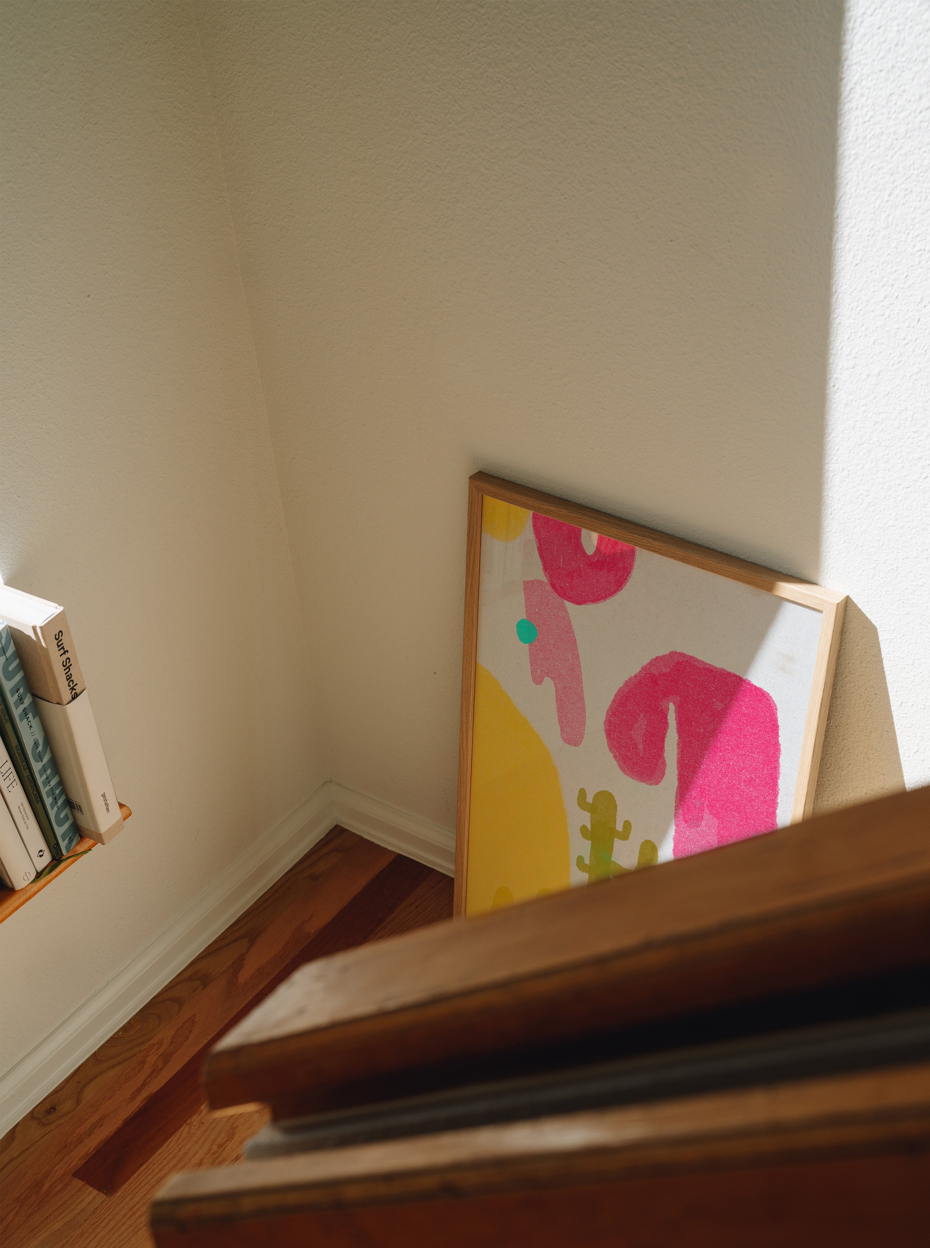 Cactus Blobs colorful print in frame propped against wall with natural shadows, playful wall art styling inspiration