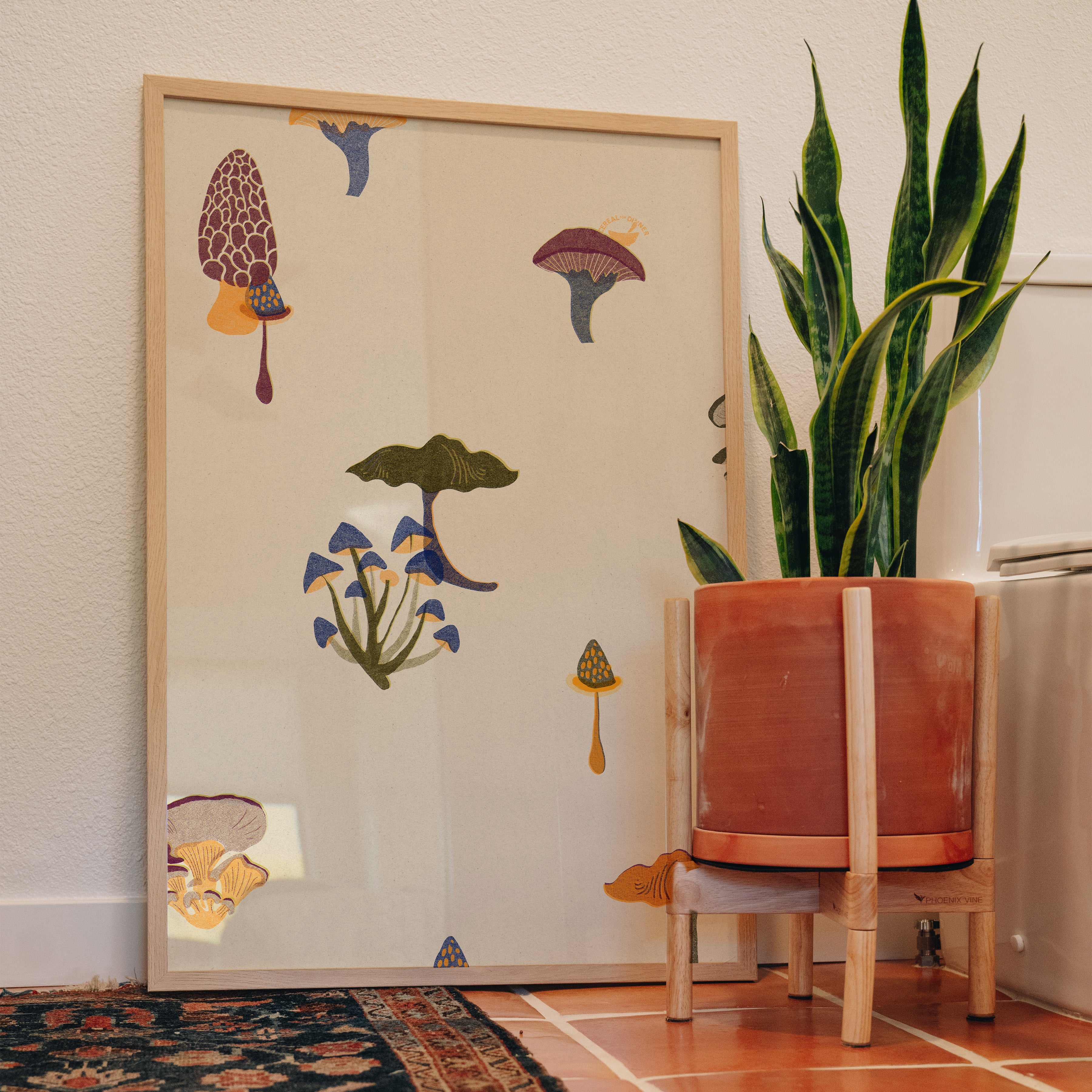 Festive Fungi botanical print displayed in bathroom with terracotta tile floor and vintage rug, colorful wall art styling inspiration