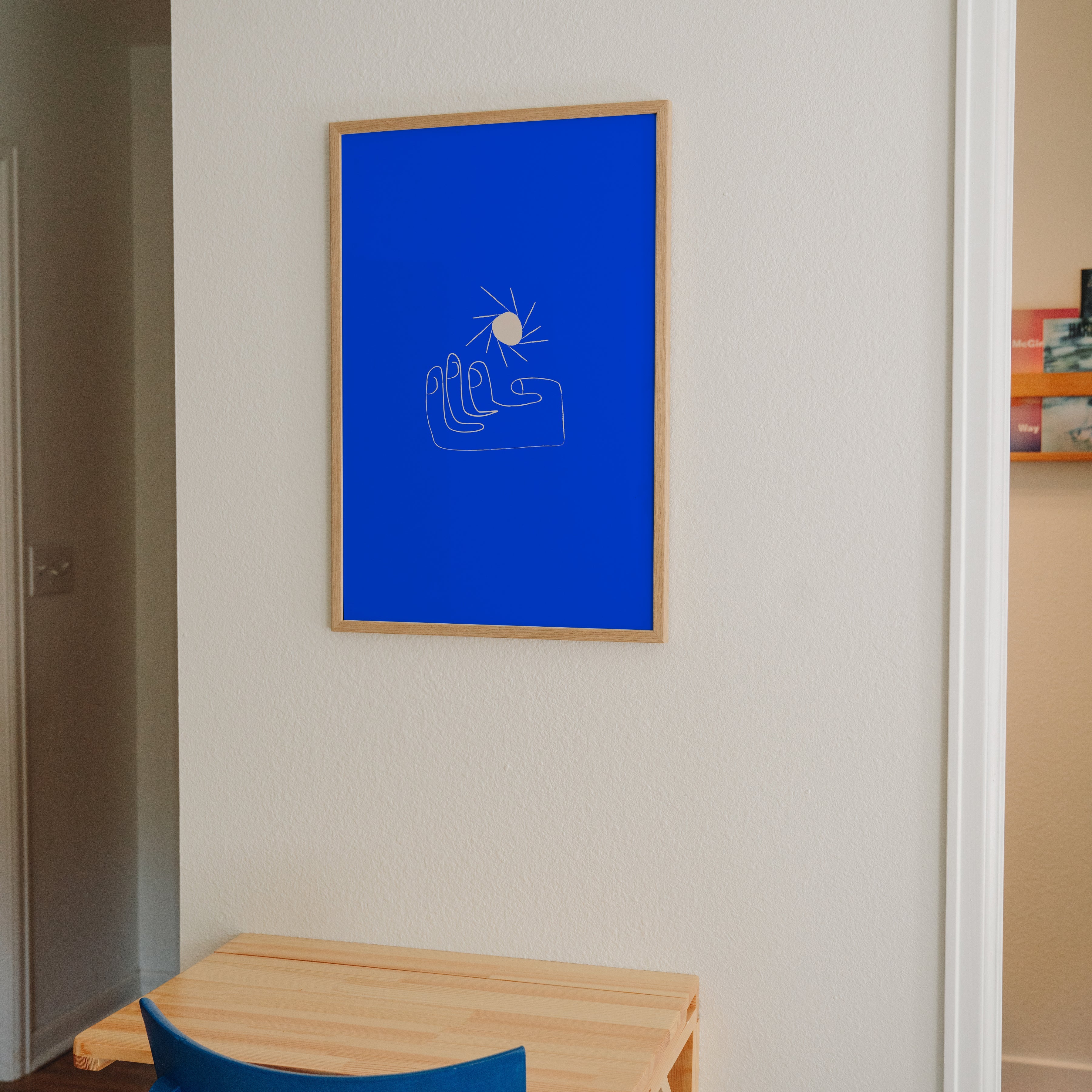 Hold the Light sun and hand print displayed in home office with matching blue chair, charming blue wall art styling inspiration
