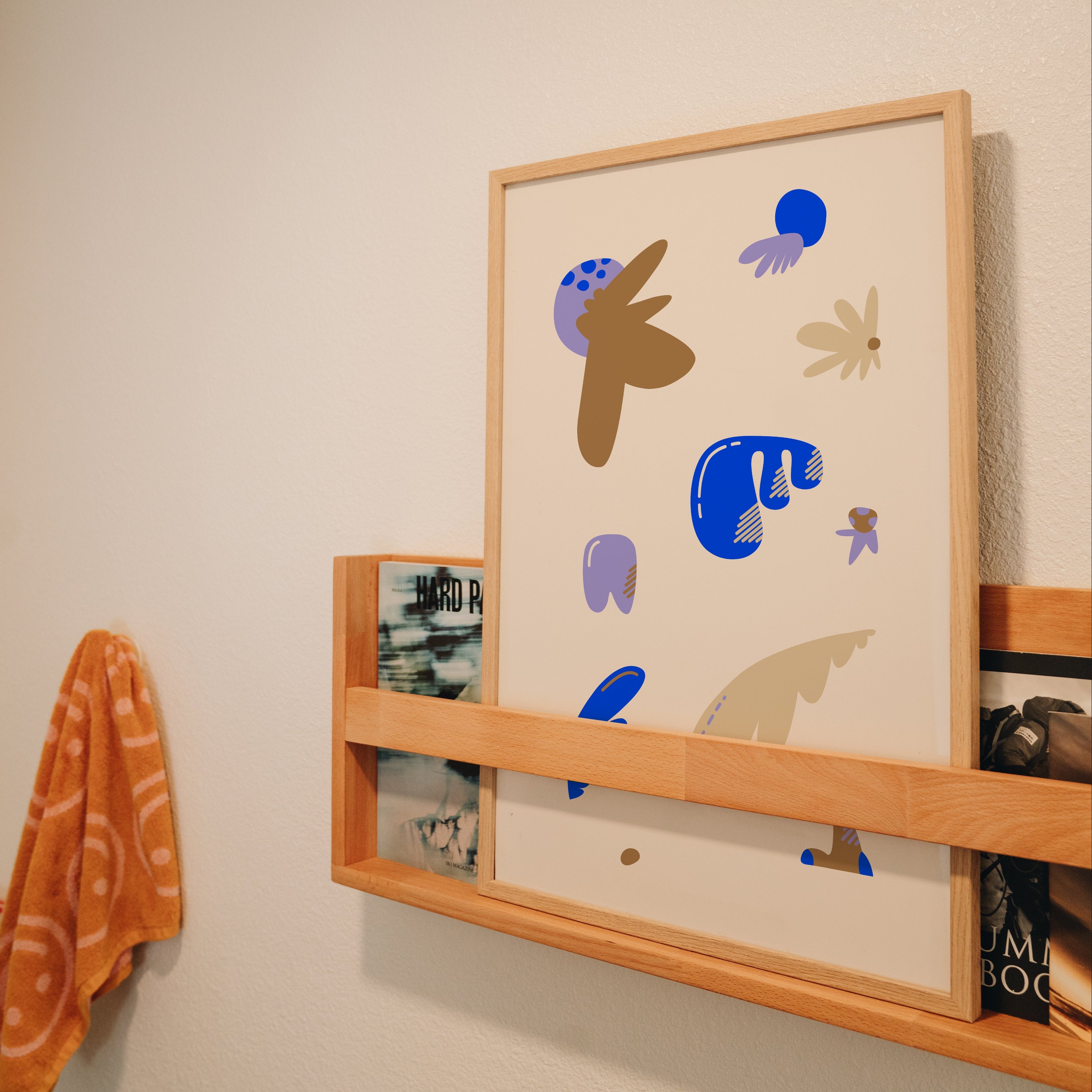 Floral whimsical print displayed in bathroom magazine rack, quirky wall art styling inspiration