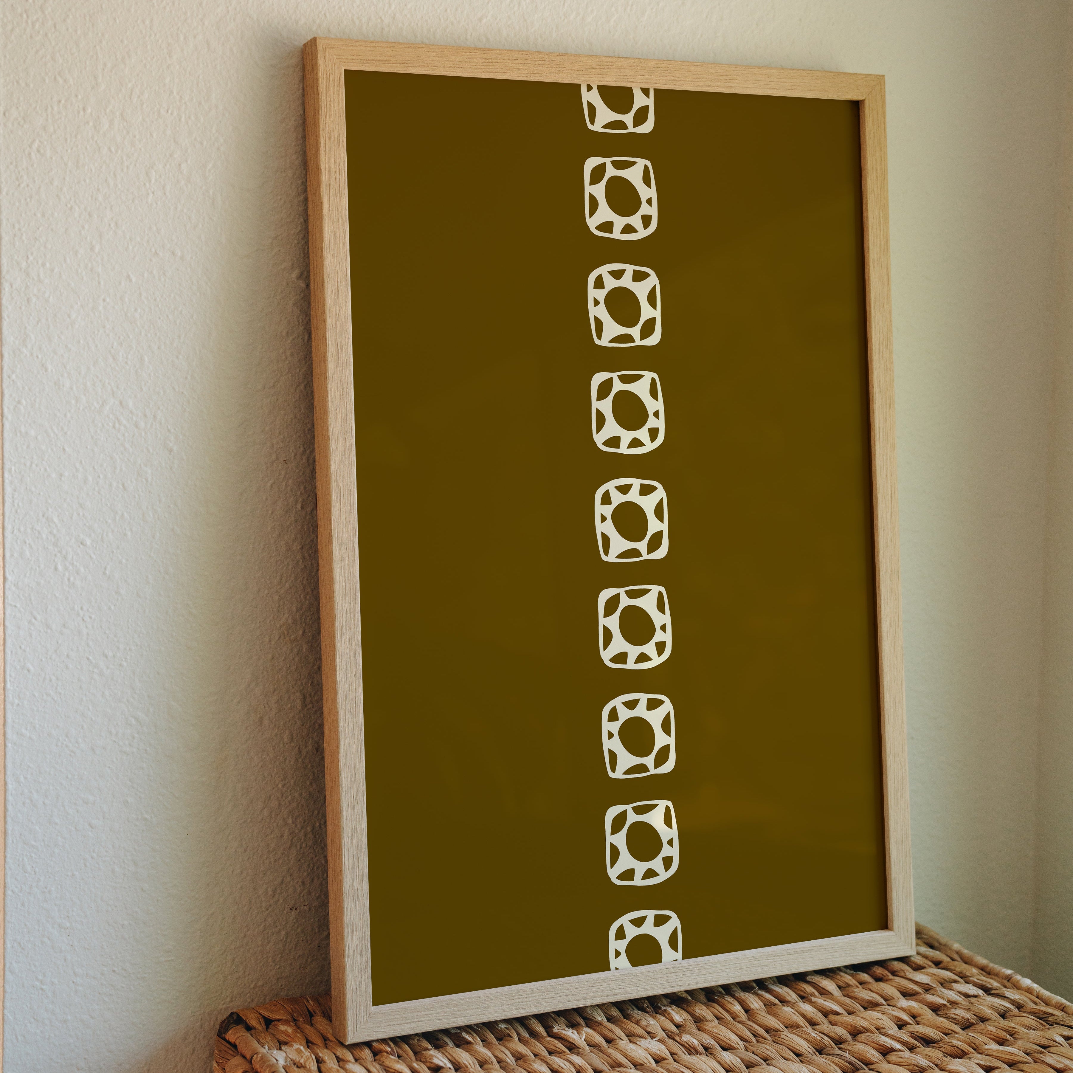 Sun Chain minimalist print in frame propped against white wall on wicker box, neutral cozy wall art styling inspiration