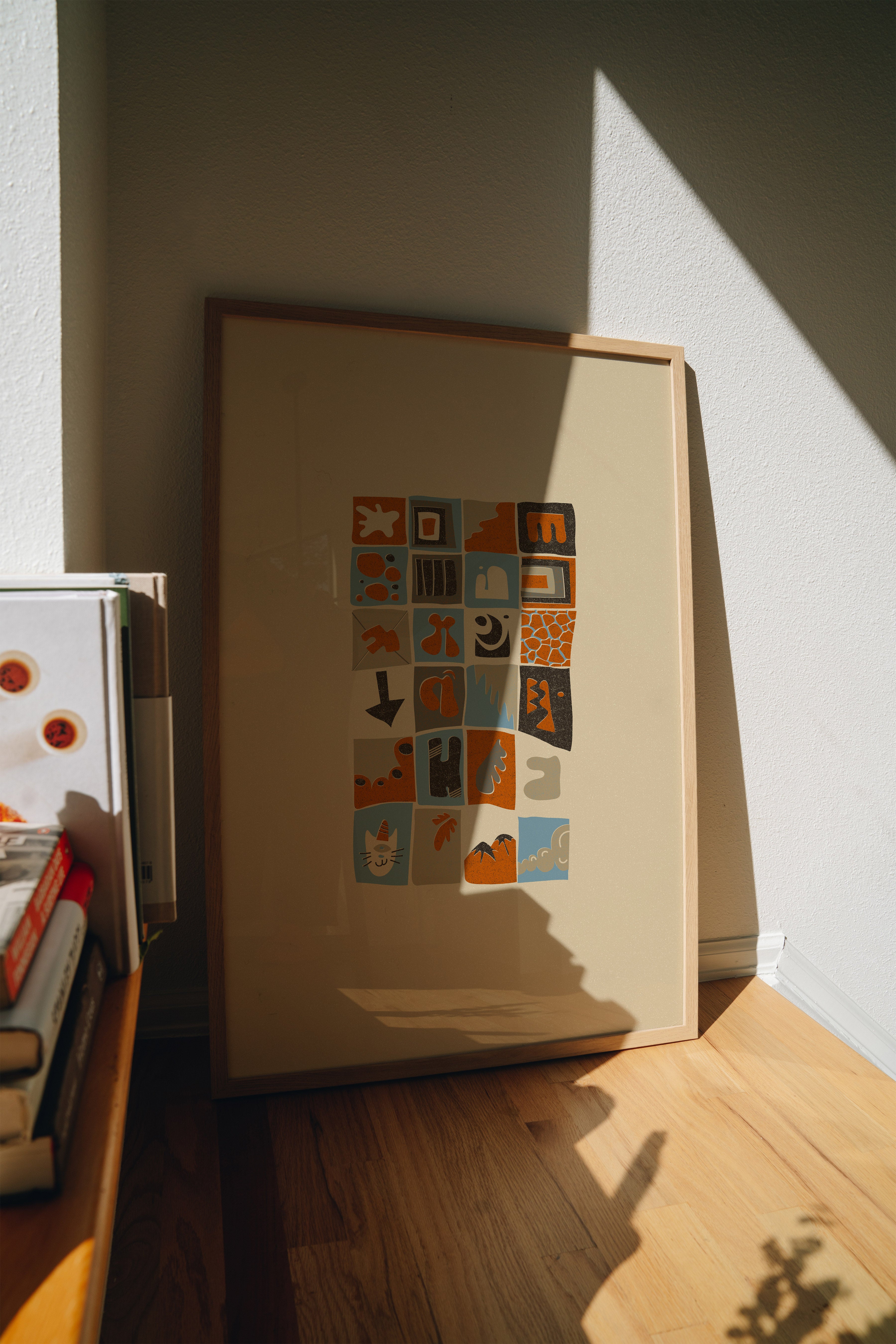 Abstract grid art print leaning against wall with organic shapes on beige background, modern minimalist wall decor, with wooden frame